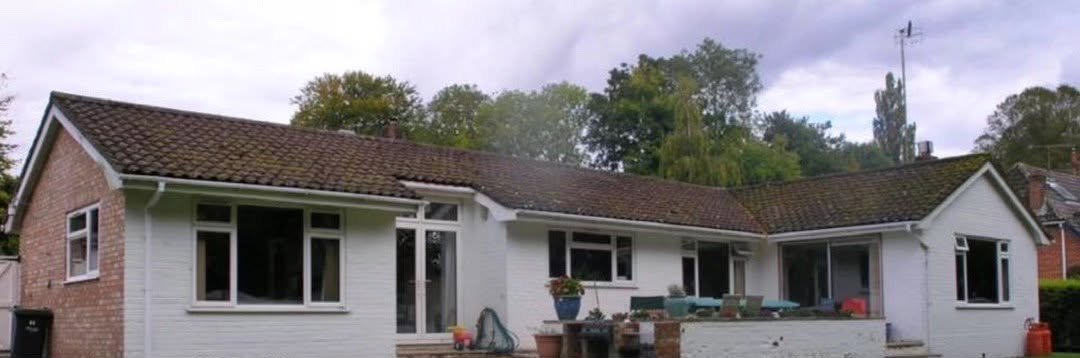Bungalow before the work: brick and painted walls, old tiled roof