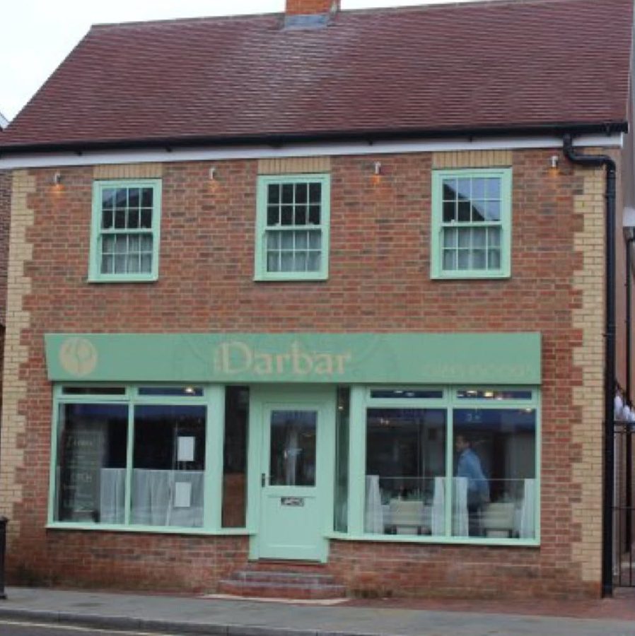 The same site after: new brick building with sash windows and restaurant shopfront