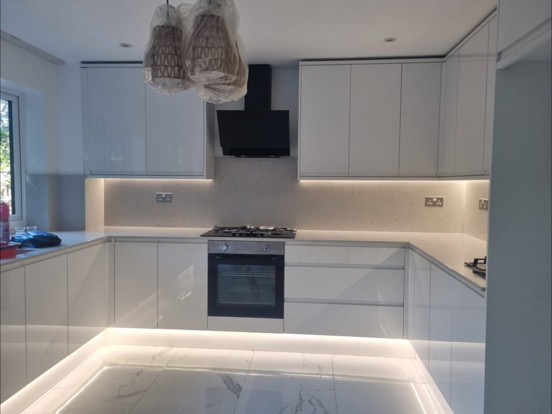 White gloss kitchen with plinth lighting